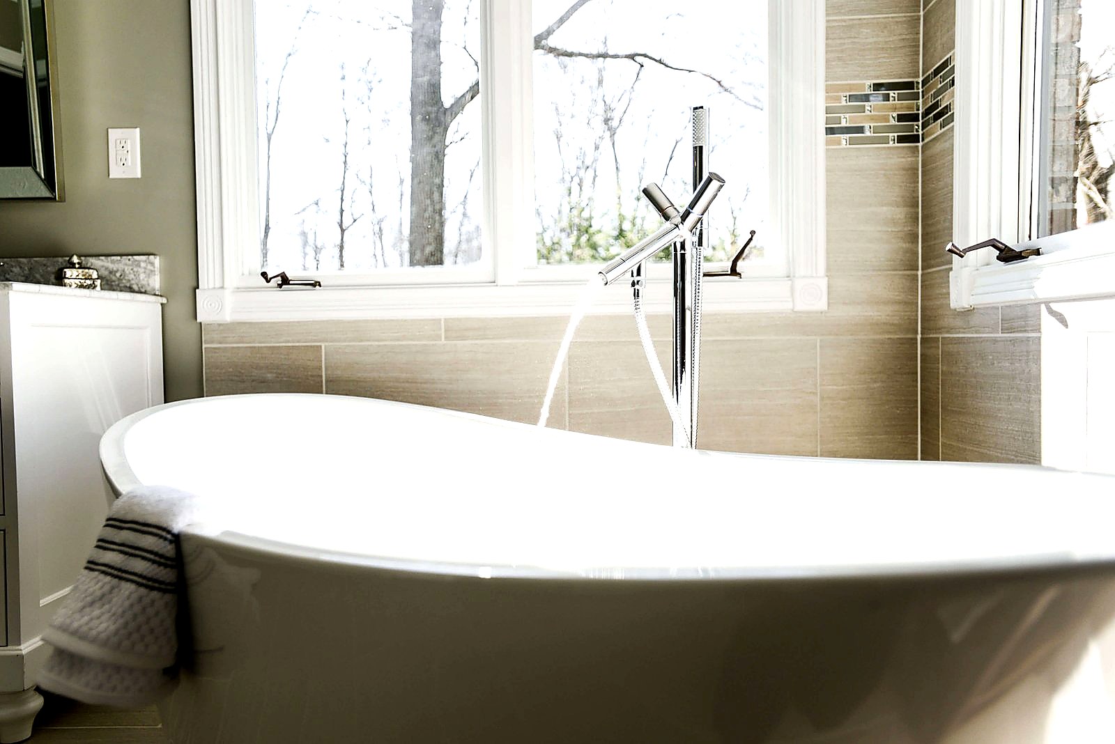 Elegant freestanding clawfoot bathtub with chrome floor-mounted faucet — clawfoot tub refinishing by Blackstone Tub Refinishers Calgary