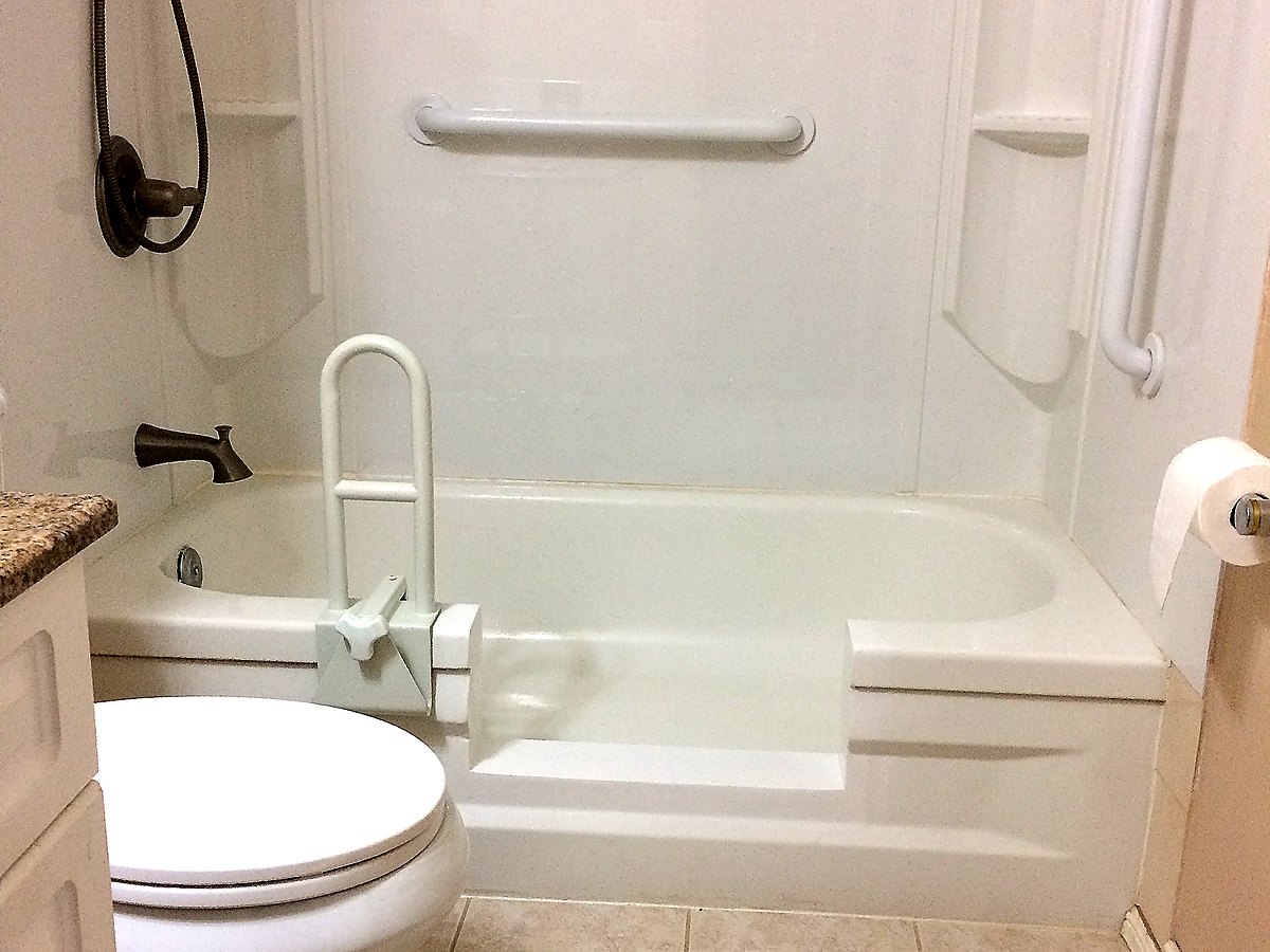 Completed tub-to-shower conversion by Blackstone Tub Refinishers Calgary — step-in entry with grab bars for senior safety
